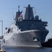 U.S. Marines and Sailors man the rails aboard the USS Arlington (LPD-24)