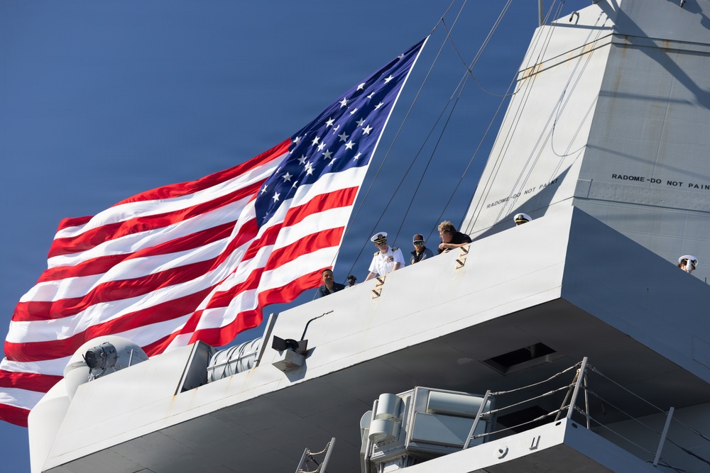 U.S. Marines and Sailors man the rails aboard the USS Arlington (LPD-24)