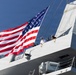 U.S. Marines and Sailors man the rails aboard the USS Arlington (LPD-24)