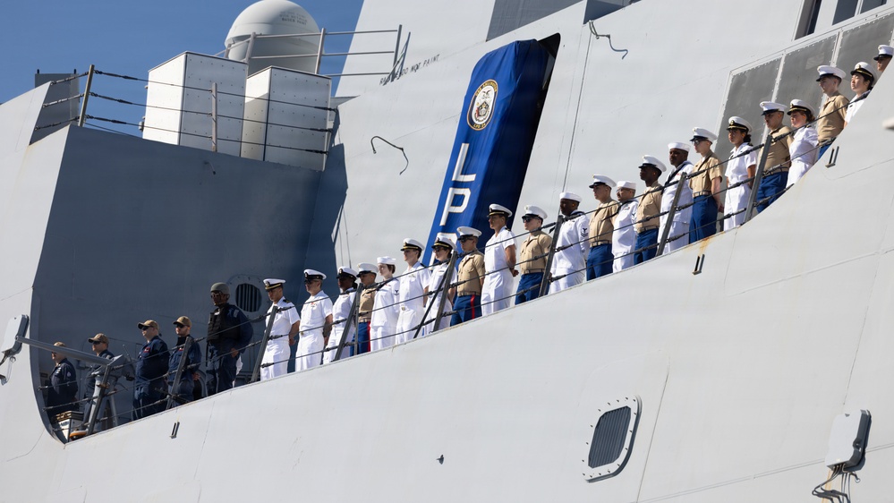 U.S. Marines and Sailors man the rails aboard the USS Arlington (LPD-24)