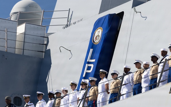 U.S. Marines and Sailors man the rails aboard the USS Arlington (LPD-24)