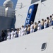 U.S. Marines and Sailors man the rails aboard the USS Arlington (LPD-24)