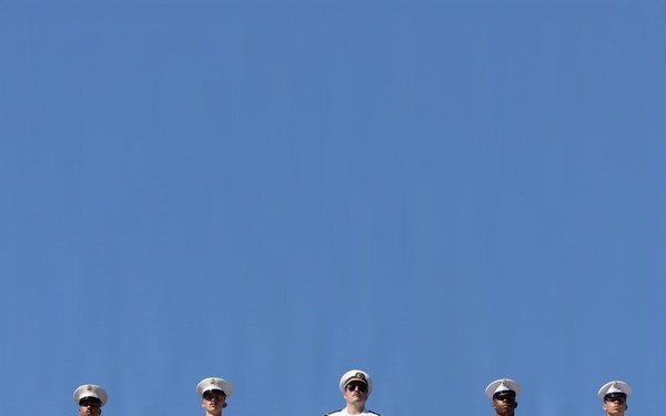 U.S. Marines and Sailors man the rails aboard the USS Arlington (LPD-24)