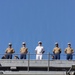 U.S. Marines and Sailors man the rails aboard the USS Arlington (LPD-24)