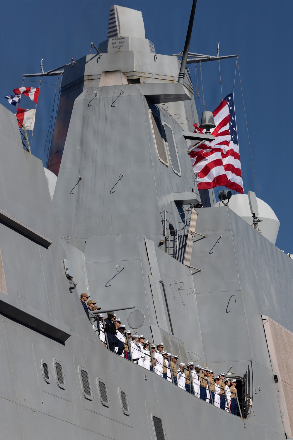 U.S. Marines and Sailors man the rails aboard the USS Arlington (LPD-24)