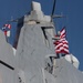 U.S. Marines and Sailors man the rails aboard the USS Arlington (LPD-24)