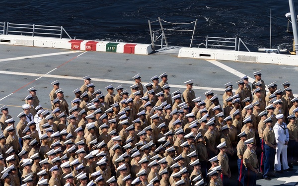 U.S. Marines and Sailors man the rails aboard the USS Arlington (LPD-24)