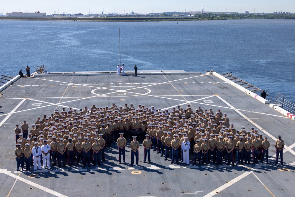 U.S. Marines and Sailors man the rails aboard the USS Arlington (LPD-24)