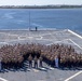 U.S. Marines and Sailors man the rails aboard the USS Arlington (LPD-24)