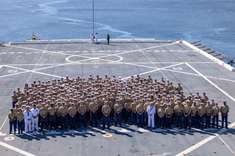 U.S. Marines and Sailors man the rails aboard the USS Arlington (LPD-24)