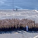 U.S. Marines and Sailors man the rails aboard the USS Arlington (LPD-24)