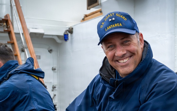 US Coast Guard Atlantic Area deputy commander handles Barque Eagle's lines during Sail250 Virginia ride-in