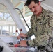 U.S. Navy Machinist’s Mate 2nd Class Zackery Herrel conducts a pre-underway maintenance check on the historic admiral's barge at Joint Base Pearl Harbor-Hickam