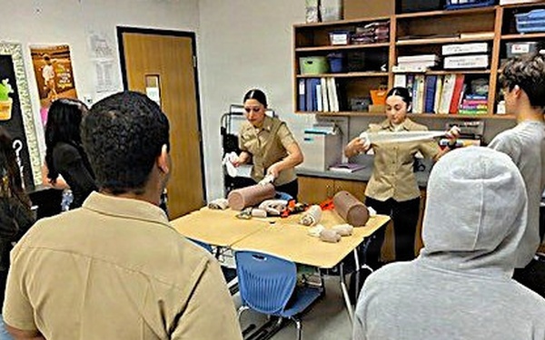 Hands-On Lifesaving Skills: Navy Corpsmen Mentor Middle School Students