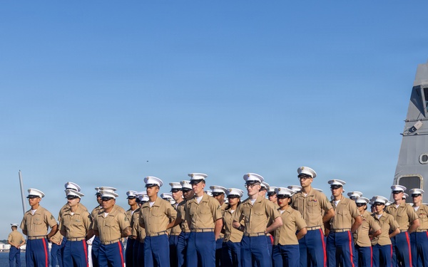 U.S. Marines and Sailors man the rails aboard the USS Arlington (LPD-24)