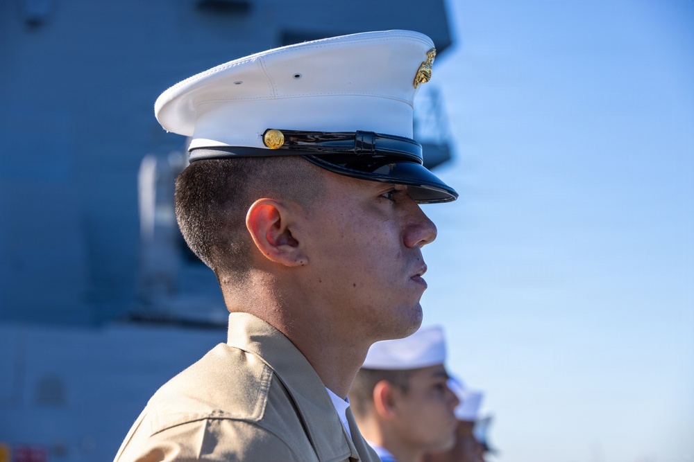 U.S. Marines and Sailors man the rails aboard the USS Arlington (LPD-24)