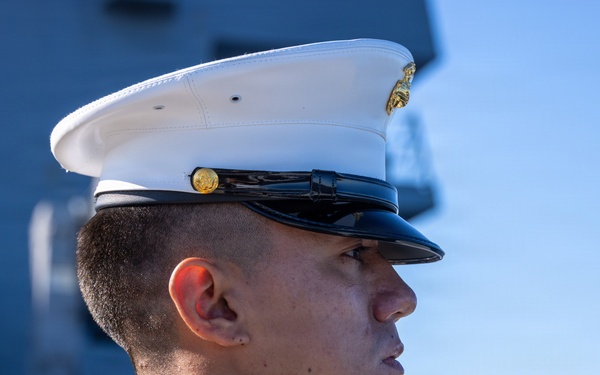 U.S. Marines and Sailors man the rails aboard the USS Arlington (LPD-24)