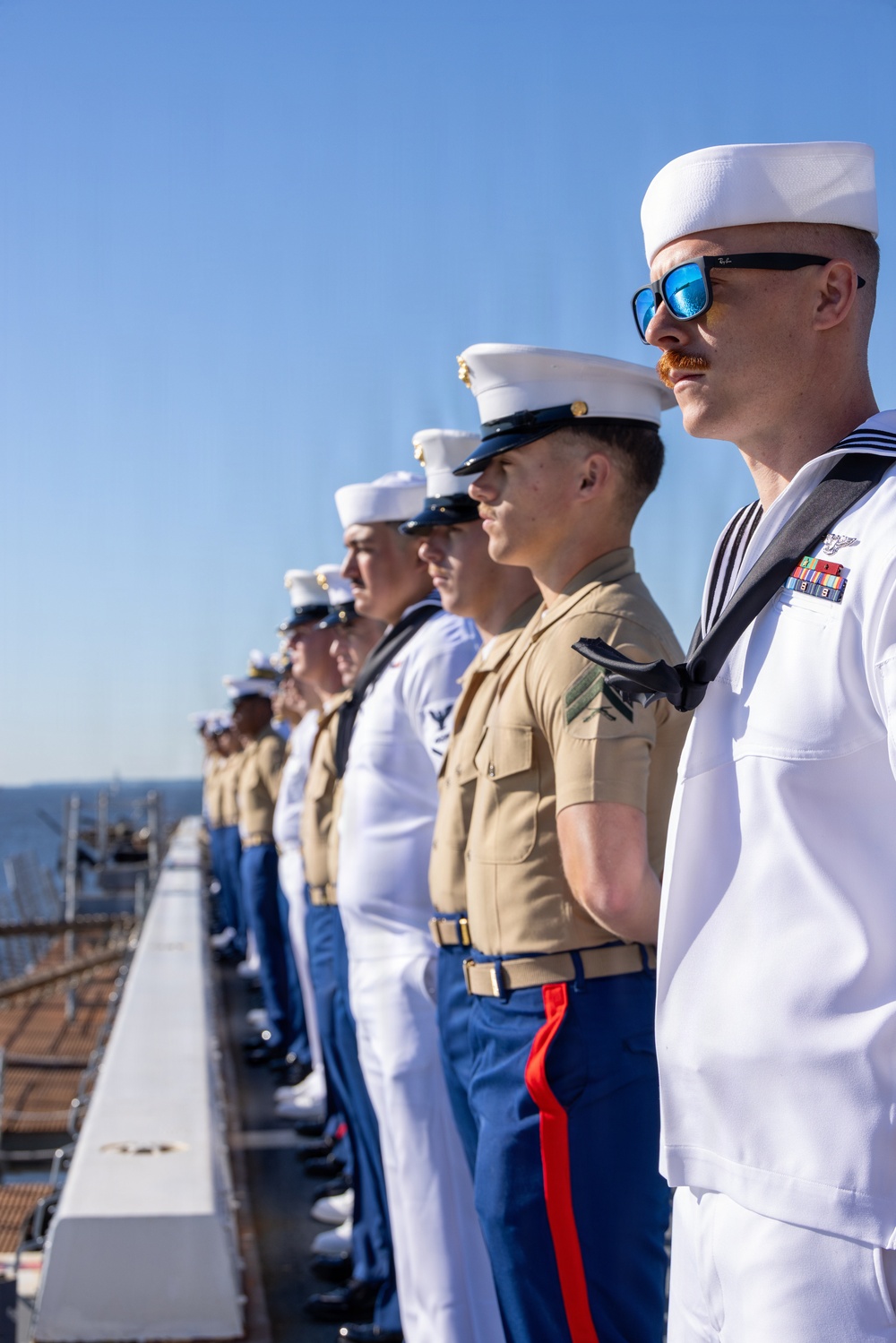 U.S. Marines and Sailors man the rails aboard the USS Arlington (LPD-24)