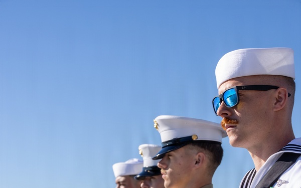 U.S. Marines and Sailors man the rails aboard the USS Arlington (LPD-24)