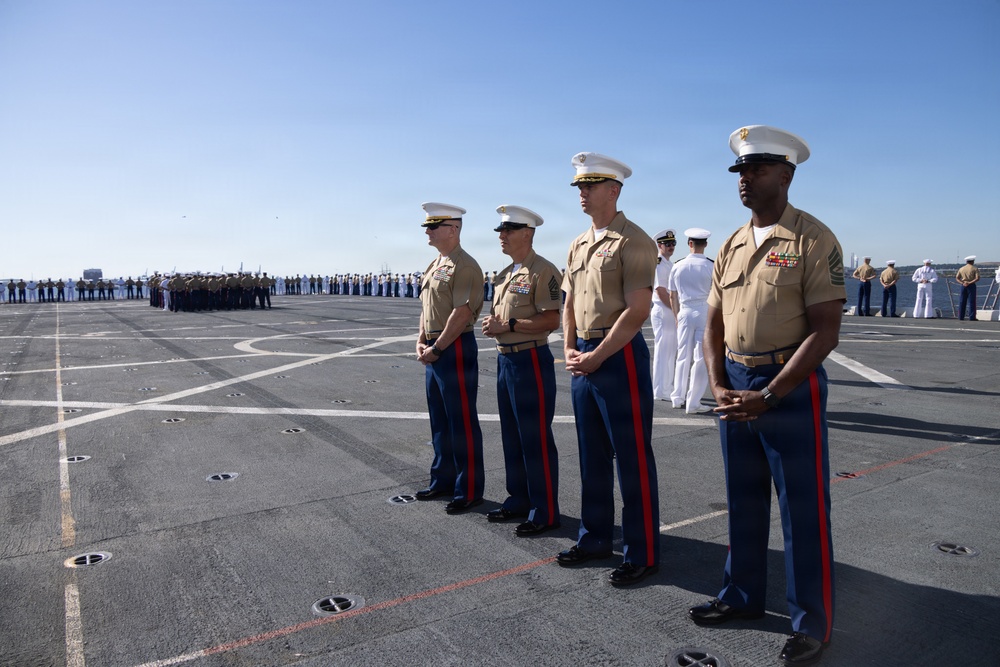 U.S. Marines and Sailors man the rails aboard the USS Arlington (LPD-24)