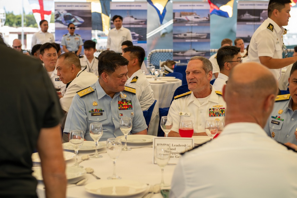 Service members attend reception onboard Philippine Coast Guard Ship BRP Gabriele Siland during RIMPAC