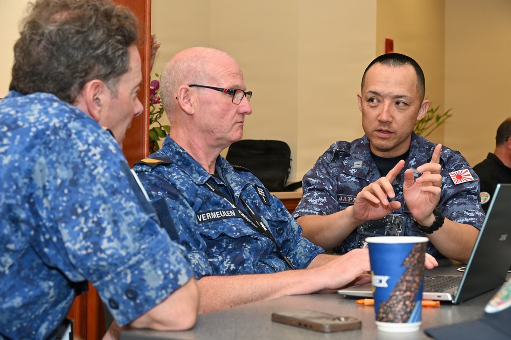 Japan Maritime Self-Defense Force and Royal Australian Navy officers confer during RIMPAC 26