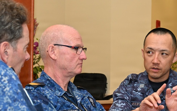 Japan Maritime Self-Defense Force and Royal Australian Navy officers confer during RIMPAC 26