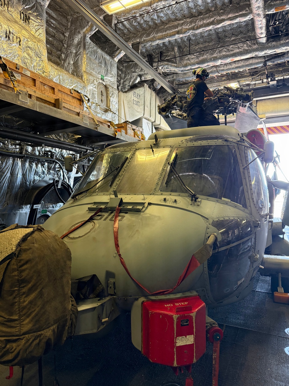 A U.S. Sailor conducts maintenance on an MH-60R Seahawk helicopter assigned to Helicopter Maritime Strike Squadron (HSM) 48, while aboard the littoral combat ship USS Billings (LCS 15) in port at Ponce, Puerto Rico, June 26, 2026.