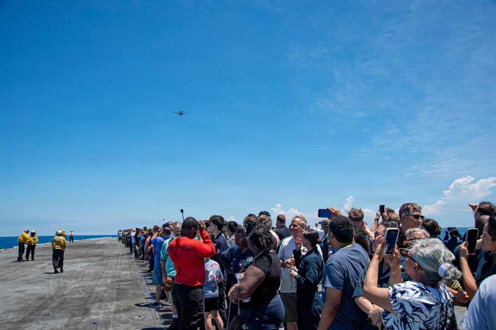Sailors' Friends And Family Members Watch C-2A Greyhound Flyby