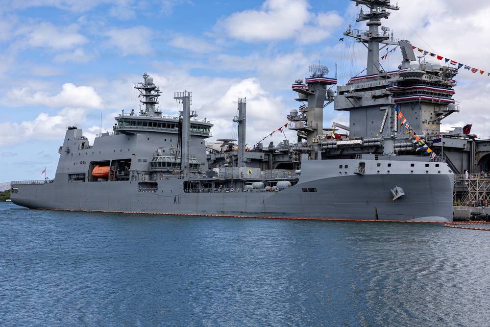 Royal New Zealand Navy vessel and U.S. Navy aircraft carrier moor at Joint Base Pearl Harbor-Hickam for RIMPAC 26