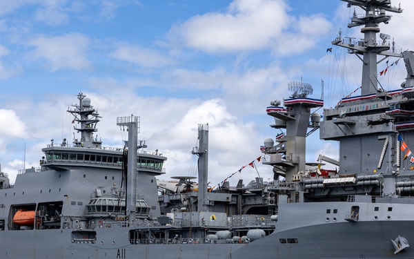 Royal New Zealand Navy vessel and U.S. Navy aircraft carrier moor at Joint Base Pearl Harbor-Hickam for RIMPAC 26