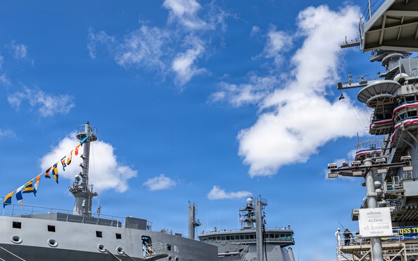 Royal New Zealand Navy vessel and U.S. Navy aircraft carrier moor at Joint Base Pearl Harbor-Hickam for RIMPAC 26