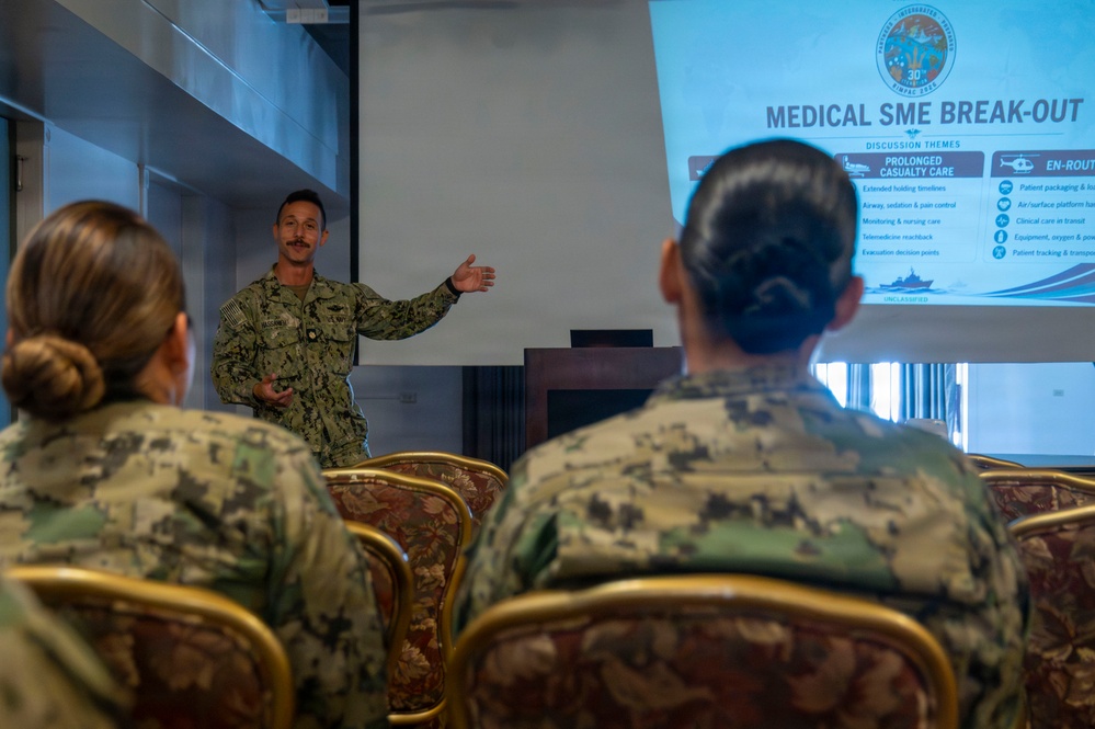Multinational service members participate in a RIMPAC medical training
