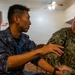Multinational service members participate in a RIMPAC medical training
