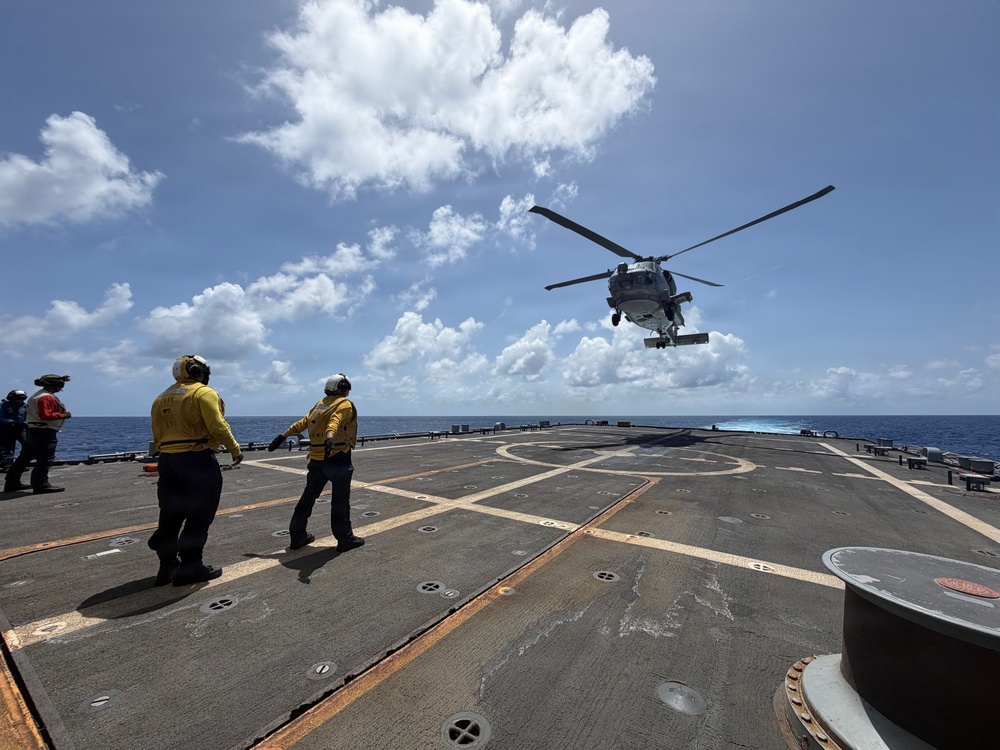 U.S. Sailors signal an MH-60R Seahawk helicopter assigned to Helicopter Maritime Strike Squadron (HSM) 48, during flight operations aboard the littoral combat ship USS Billings (LCS 15) while operating in the Caribbean Sea, June 27, 2026.