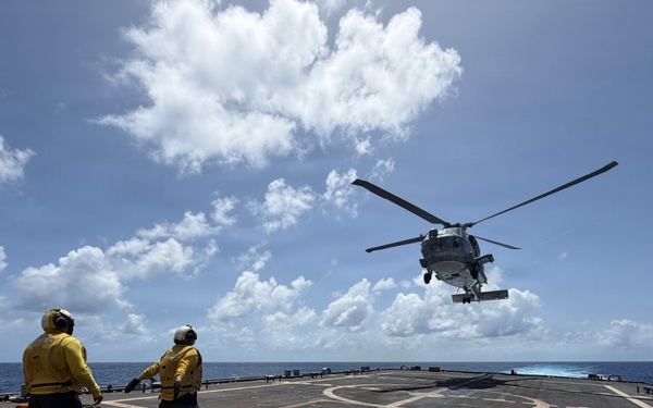 U.S. Sailors signal an MH-60R Seahawk helicopter assigned to Helicopter Maritime Strike Squadron (HSM) 48, during flight operations aboard the littoral combat ship USS Billings (LCS 15) while operating in the Caribbean Sea, June 27, 2026.