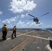U.S. Sailors signal an MH-60R Seahawk helicopter assigned to Helicopter Maritime Strike Squadron (HSM) 48, during flight operations aboard the littoral combat ship USS Billings (LCS 15) while operating in the Caribbean Sea, June 27, 2026.