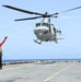 A U.S. Sailor signals a UH-1Y Venom helicopter, assigned to Marine Medium Tiltrotor Squadron (VMM) 365 (Reinforced), Littoral Combat Force 24.