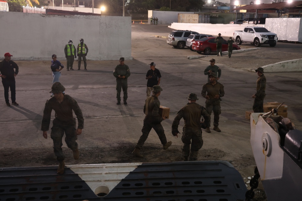 U.S. Sailors and Marines, with Littoral Combat Force 24, unload Meals, Ready-to-Eat boxes from Landing Craft Utility (LCU) 1662, assigned to Assault Craft Unit (ACU) 2, in La Guaira, Venezuela, June 27, 2026.