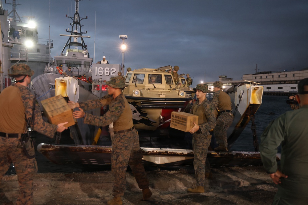 U.S. Sailors and marines unload Meals, Ready-to-Eat boxes from Landing Craft Utility (LCU) 1662, assigned to Assault Craft Unit (ACU) 2, in La Guaira, Venezuela, June 27, 2026.