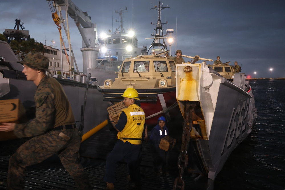 U.S. Sailors and Marines, with Littoral Combat Force 24, unload Meals, Ready-to-Eat boxes from Landing Craft Utility (LCU) 1662, assigned to Assault Craft Unit (ACU) 2, in La Guaira, Venezuela, June 27, 2026.