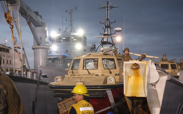 U.S. Sailors and Marines, with Littoral Combat Force 24, unload Meals, Ready-to-Eat boxes from Landing Craft Utility (LCU) 1662, assigned to Assault Craft Unit (ACU) 2, in La Guaira, Venezuela, June 27, 2026.