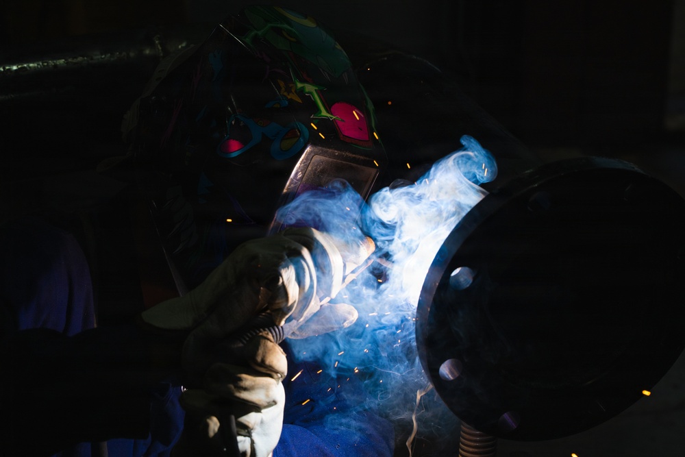 509th CES welds pipe sections for Base Exchange HVAC project