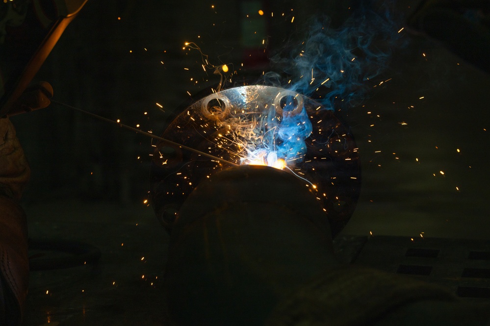 509th CES welds pipe sections for Base Exchange HVAC project