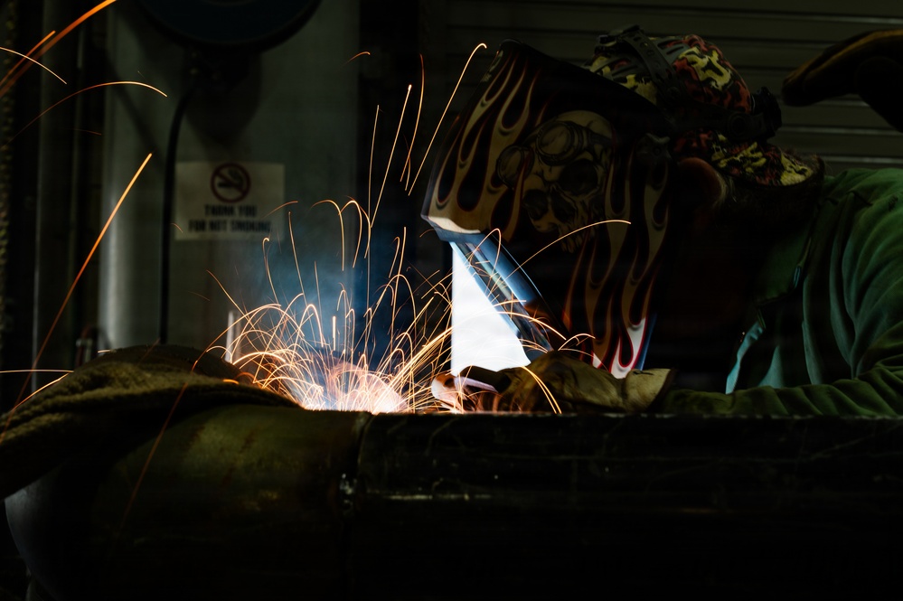 509th CES welds pipe sections for Base Exchange HVAC project