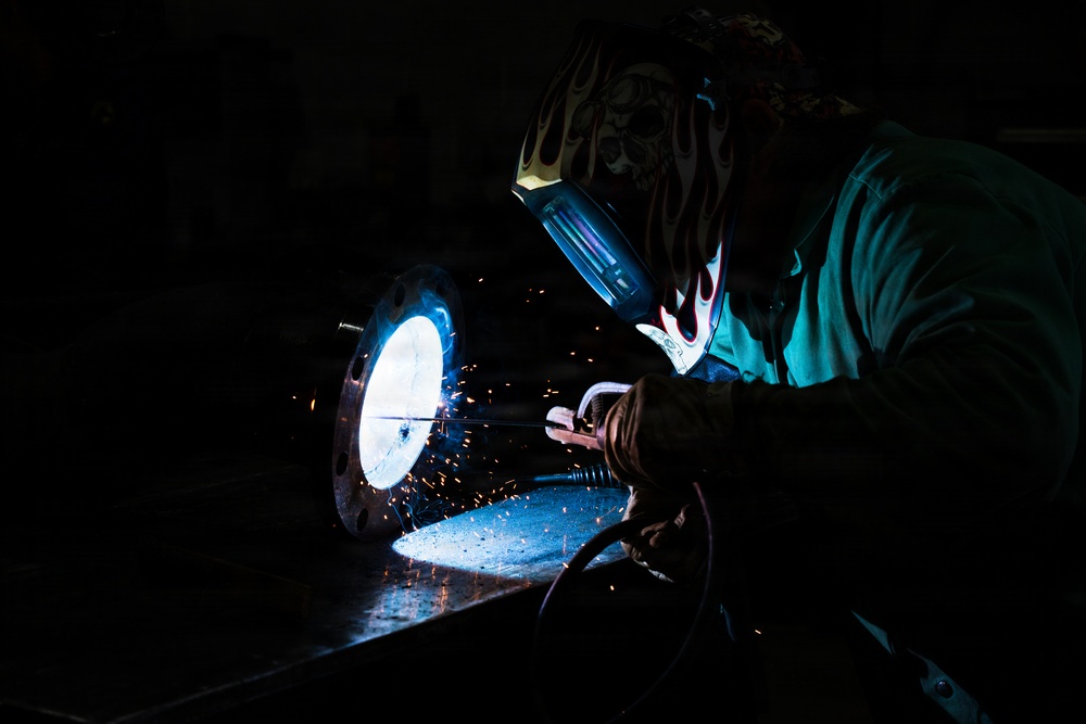 509th CES welds pipe sections for Base Exchange HVAC project