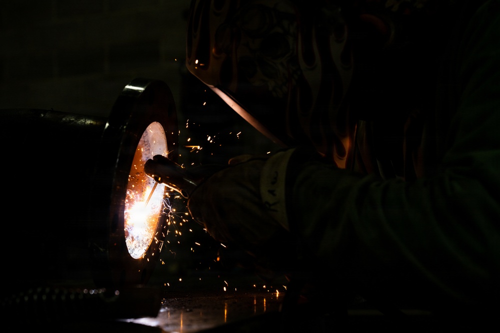 509th CES welds pipe sections for Base Exchange HVAC project