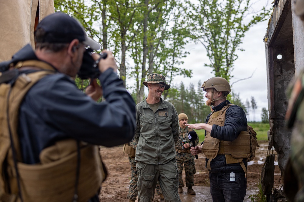 U.S. Marine Corps explosive ordnance disposal technicians engage with international media in Latvia