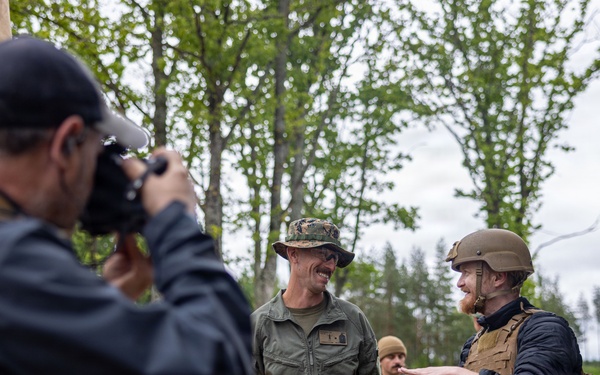 U.S. Marine Corps explosive ordnance disposal technicians engage with international media in Latvia