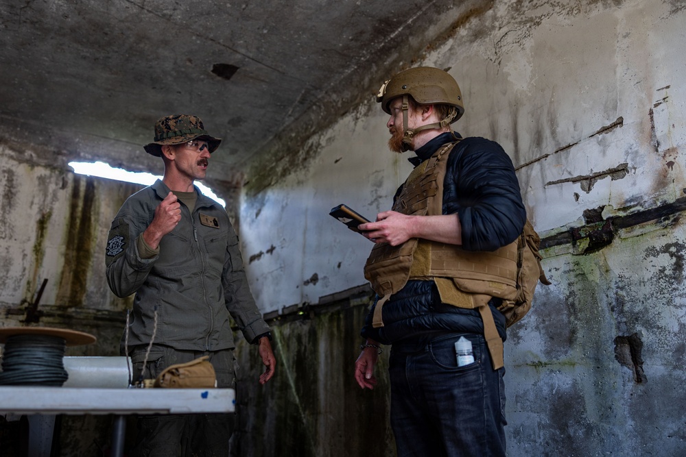 U.S. Marine Corps explosive ordnance disposal technicians engage with international media in Latvia